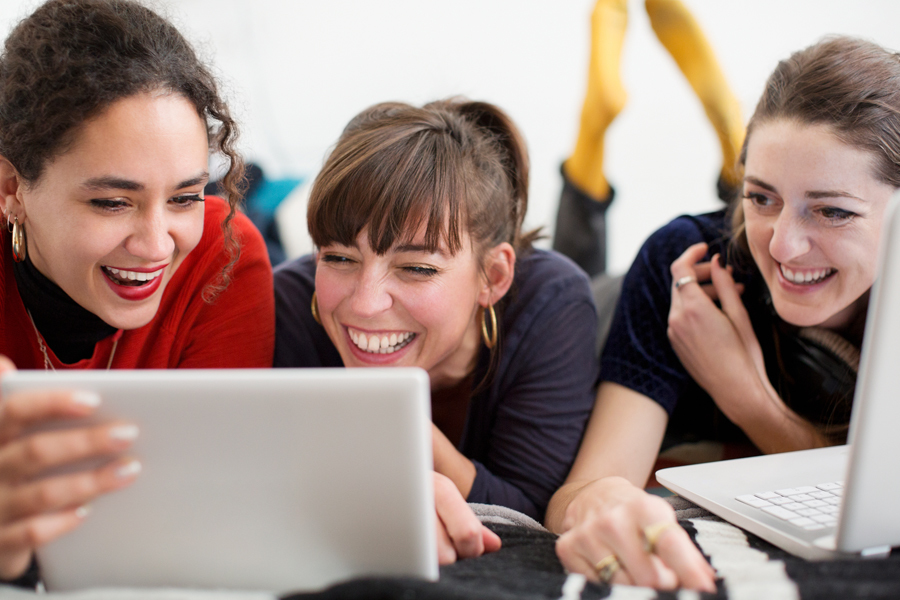 A group of women using digital devices.