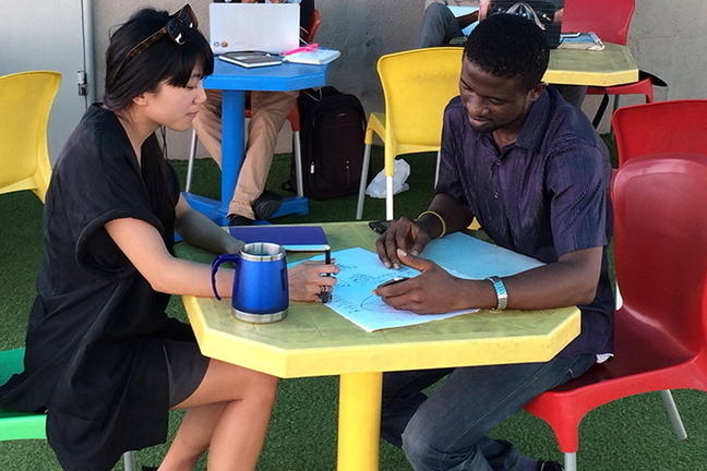 two people discussing ideas around a rable