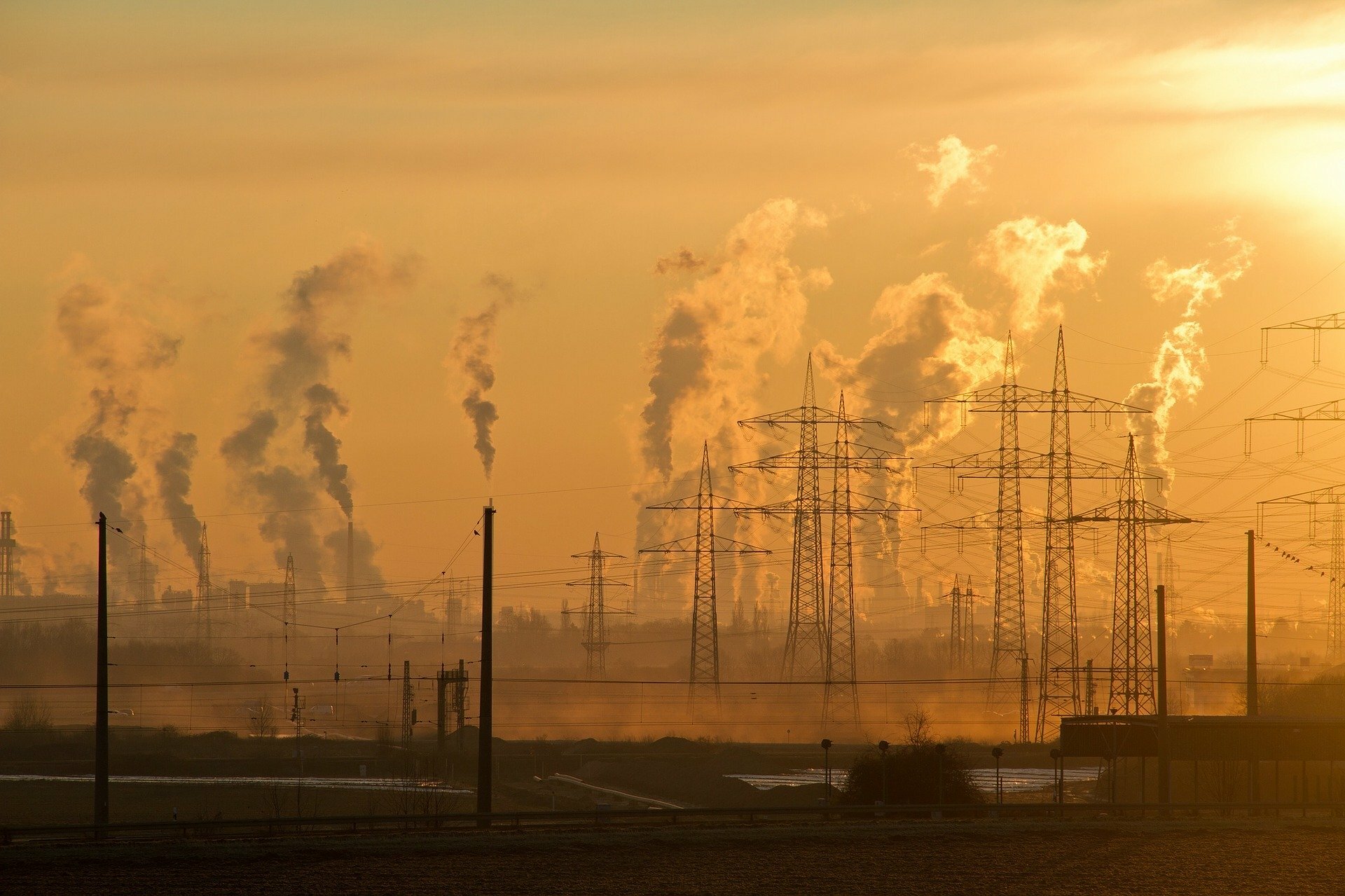 image of pollution from factories and power stations behind pylons