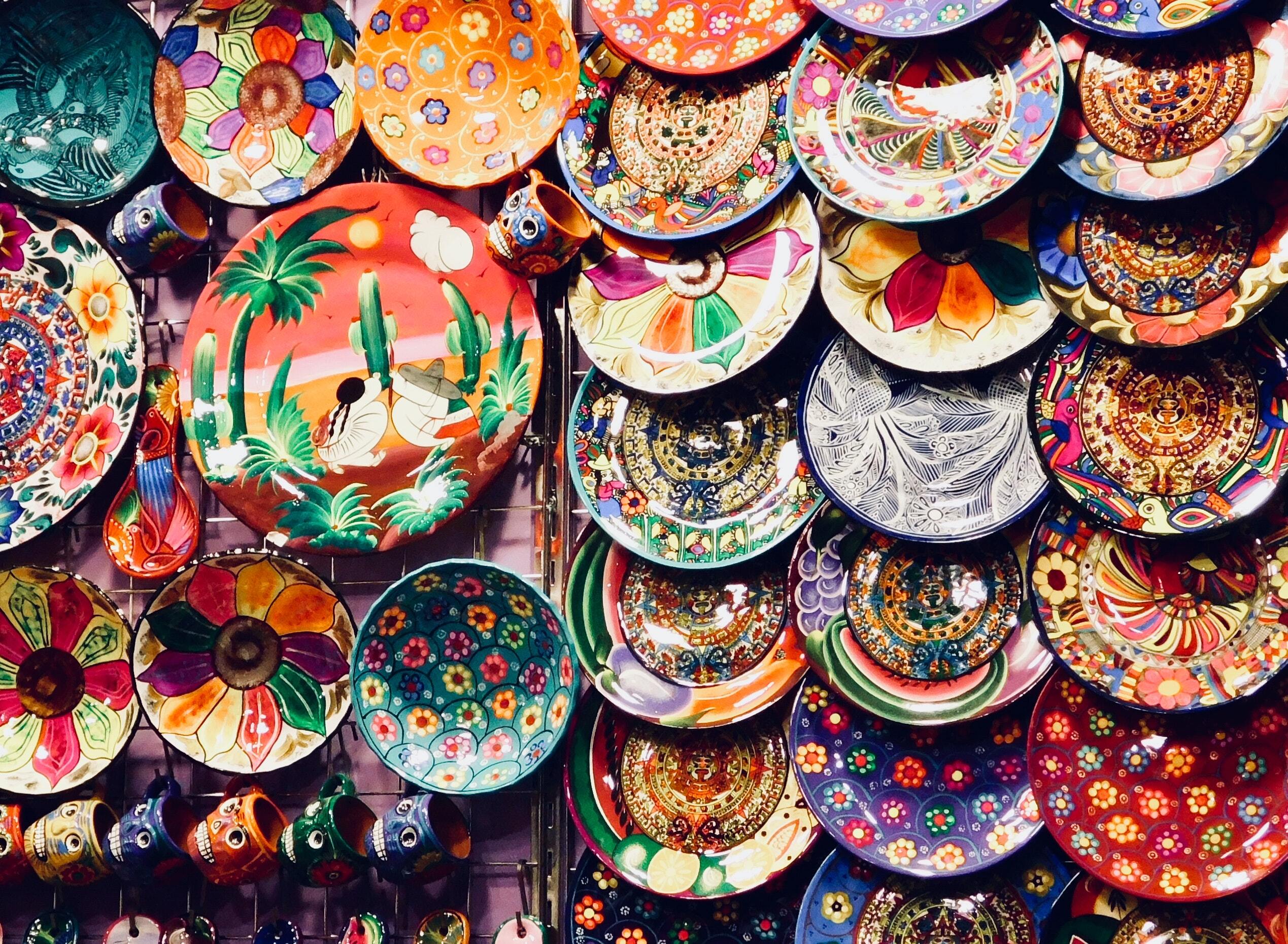 A market stall with colourful ceramic plates