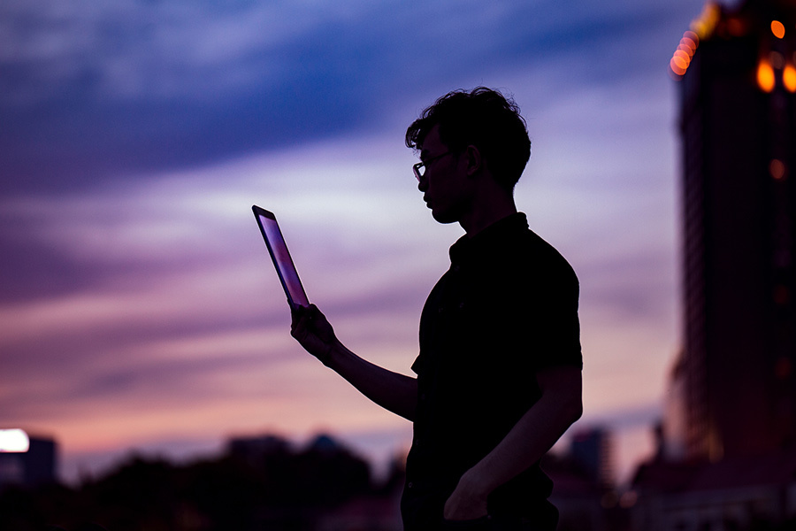 student on a tablet at sunset