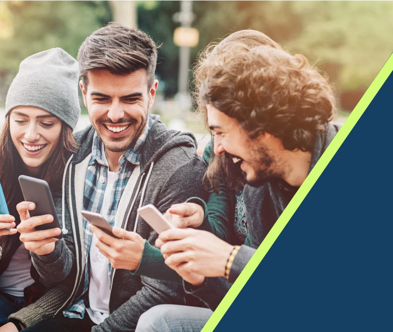 A group of happy people showing each other their phones