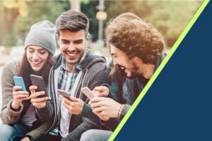 A group of happy people showing each other their phones