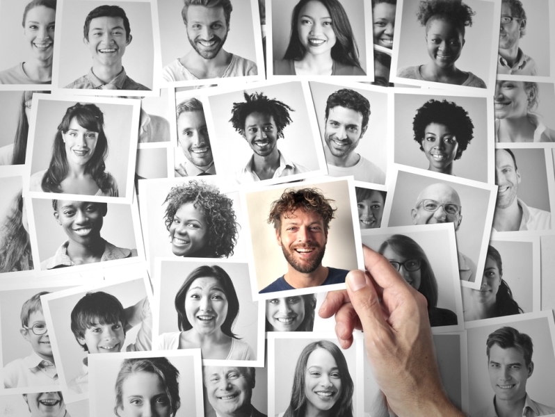 various photos of mixed cultures with one photo held in a hand