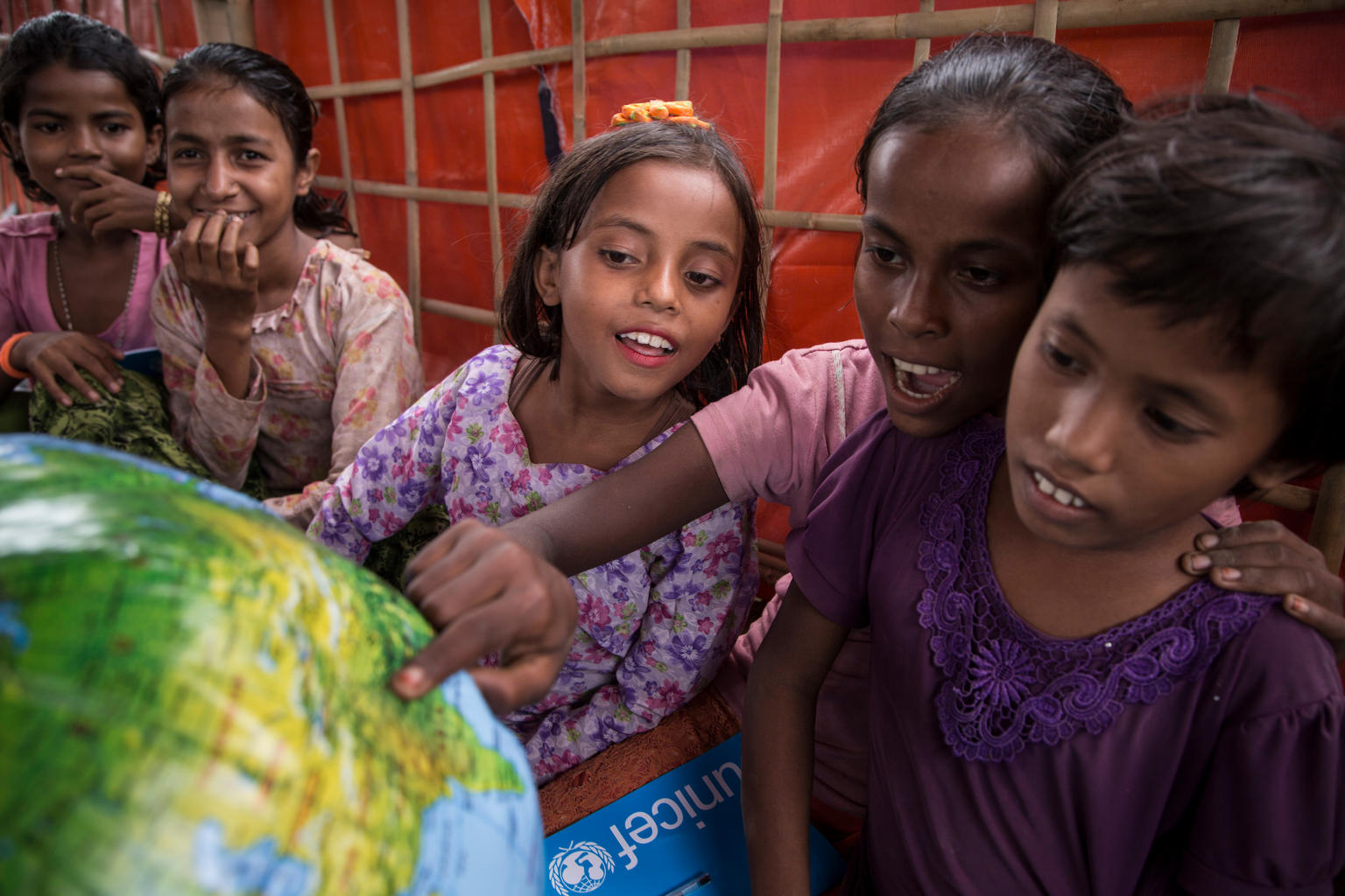 Students look at an inflatable globe, part of the educational supplies contained in a School-in-a-Box, at a new Transitional Learning Centre in the Uchiprang refugee camp, near Cox's Bazar, Bangladesh