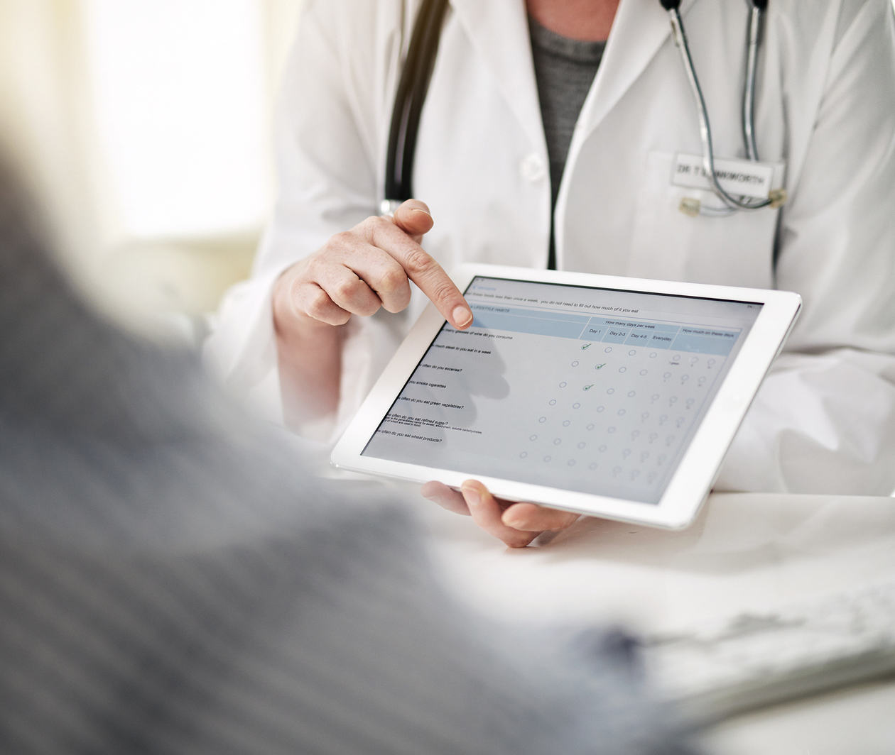 Shot of a doctor showing a senior patient some information on a digital tablet in her office