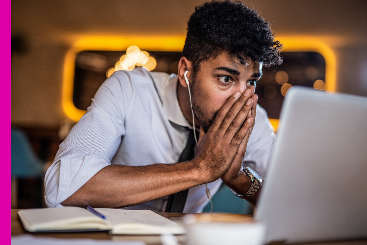 Man reacting to the computer screen in an alarming way