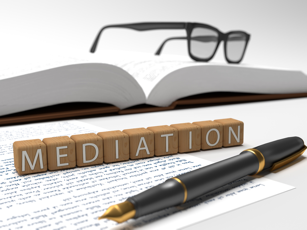 Dices containing the word Mediation, a book, glasses and a fountain pen.