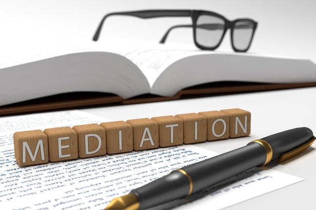 Dices containing the word Mediation, a book, glasses and a fountain pen.