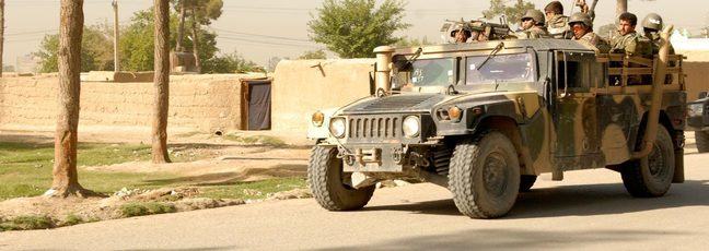 Afghan soldiers in a Humvee military vehicle.