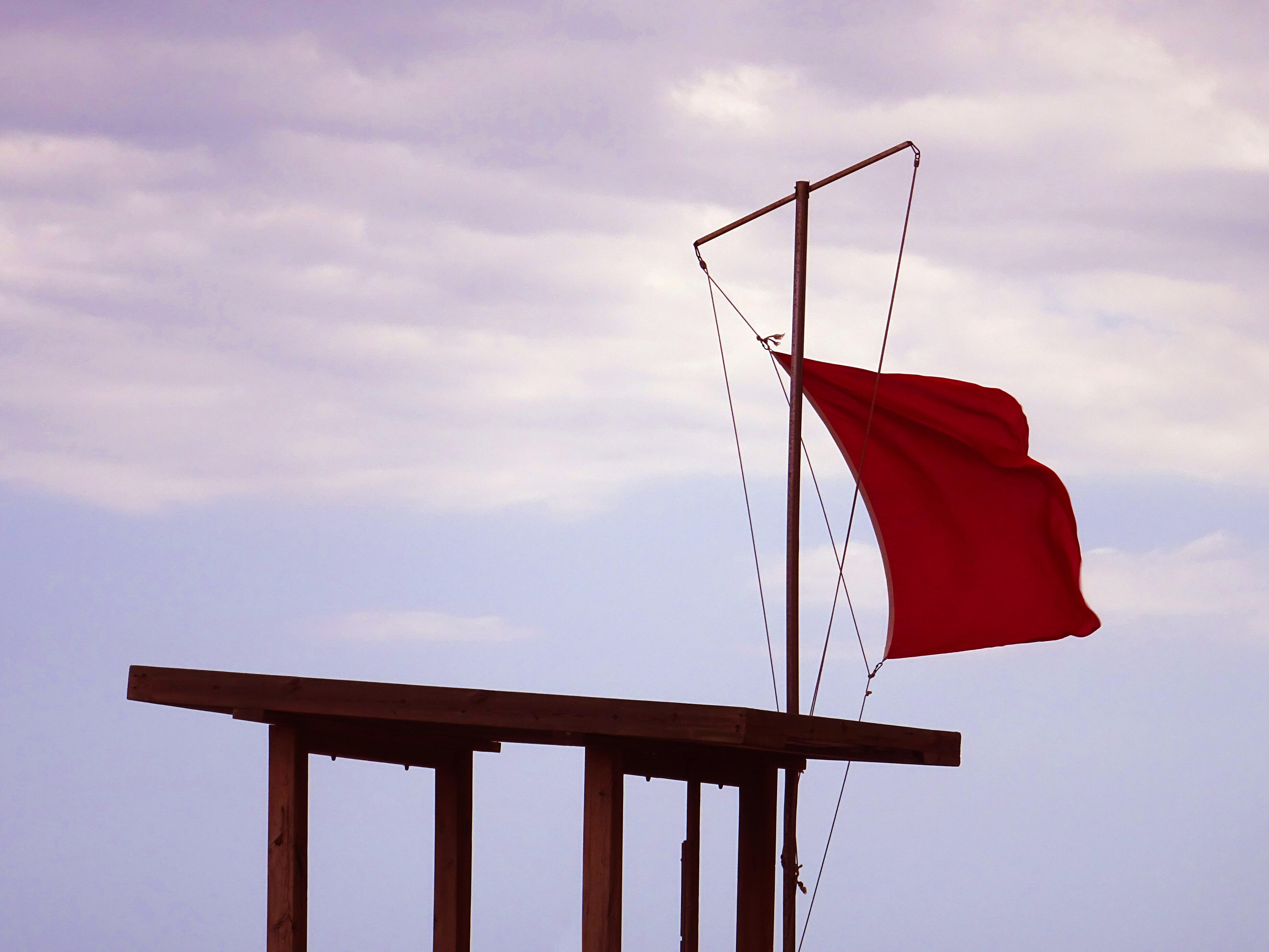 Red flag waves in the wind