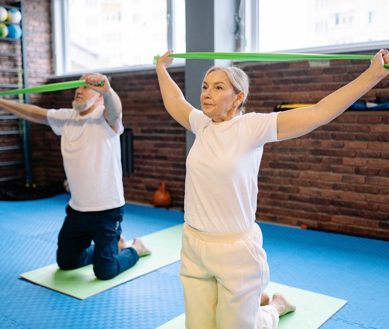 Two older people in an exercise class