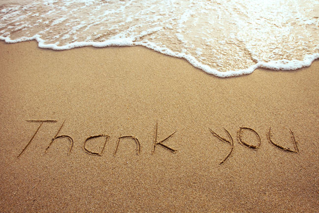 "Thank you" written on the beach.