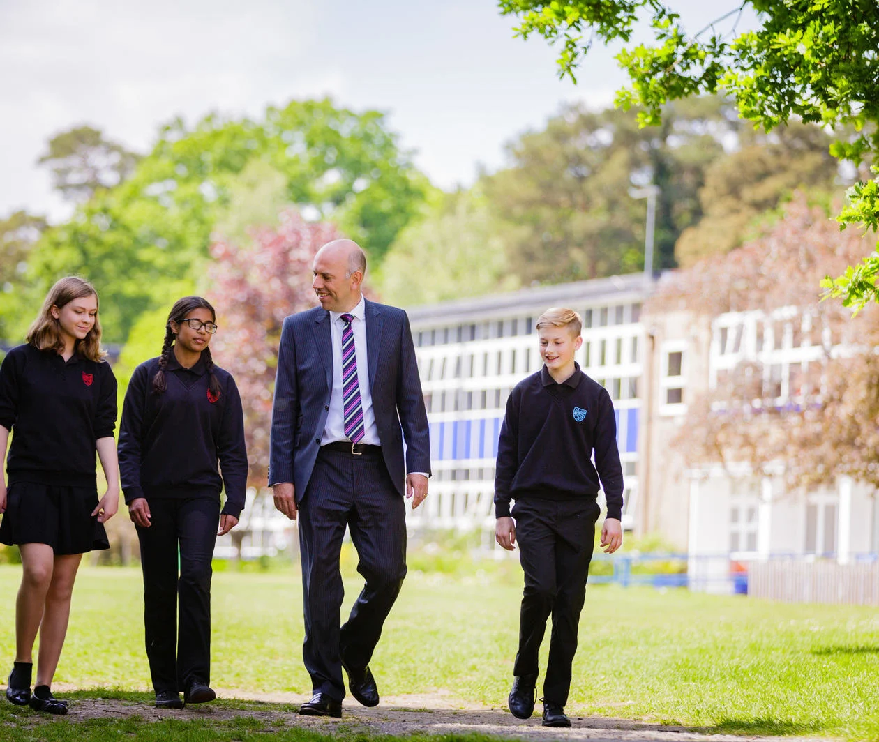 Educator and students on a school campus