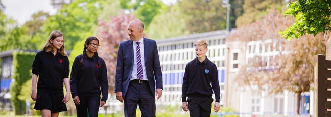 Educator and students on a school campus