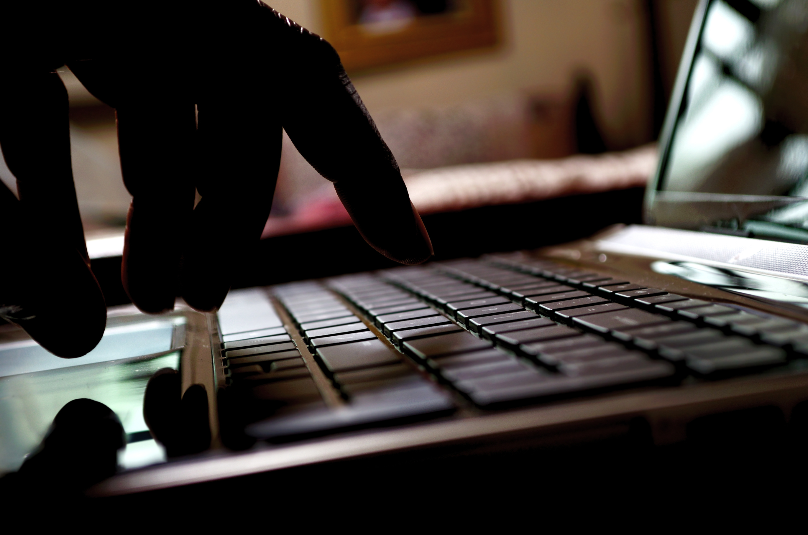 Image of hand in keyboard in the dark