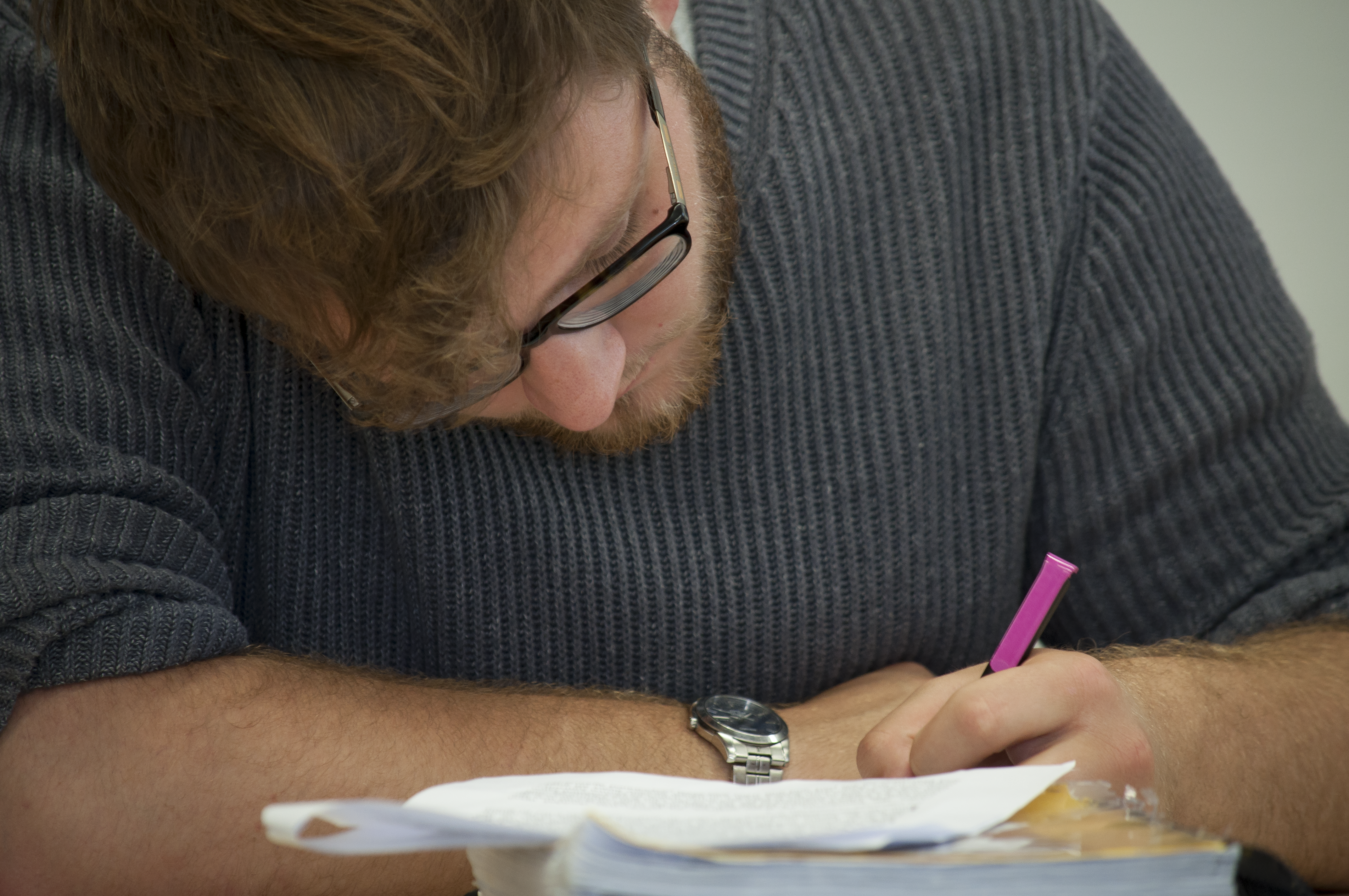 Student writing in a note book