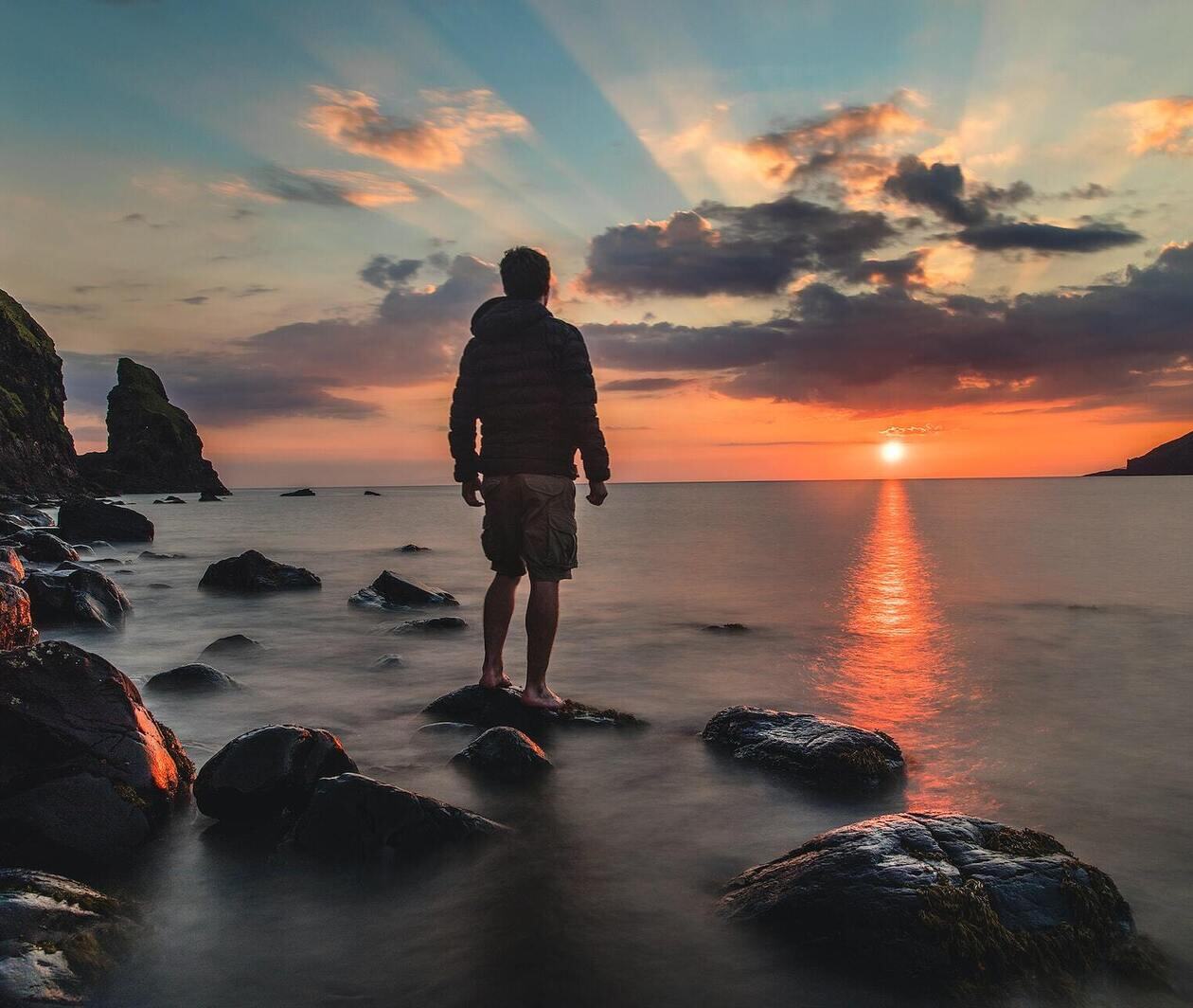 A man looking out at sunset.