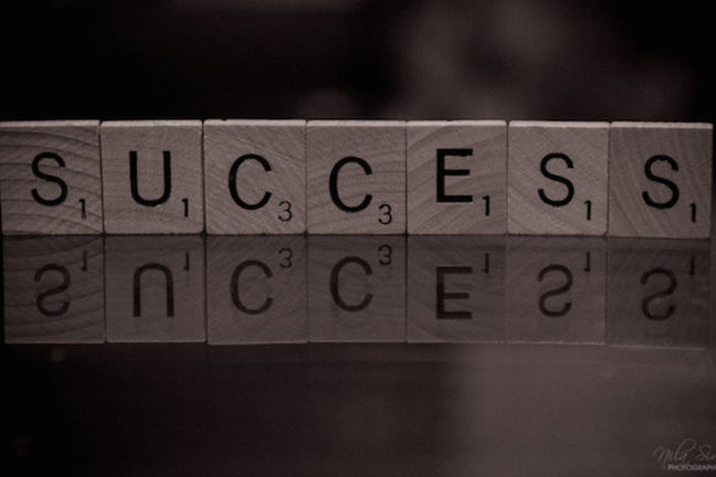 Scrabble tiles spelling the word "success'.