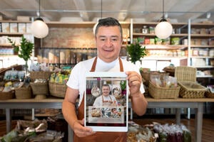 Restaurant owner holding ipad with their website