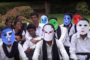 A group of young people in India wearing face masks with social media logos on.