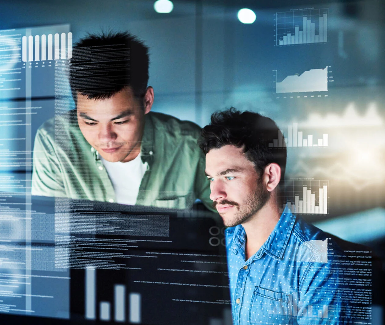 Two men looking at a screen and thinking. Graphs are displayed around them