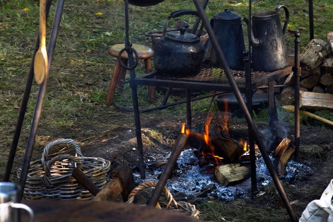 campfire with iron cookery equipment