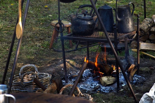 campfire with iron cookery equipment