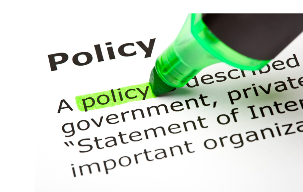 A picture of policy text with the word policy being highlighted with a green highlighter pen.