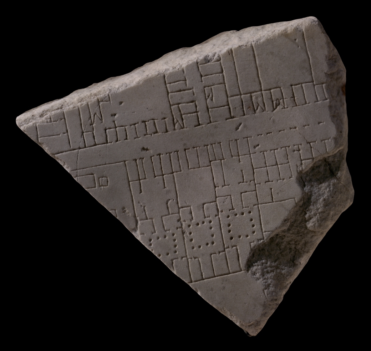 A marble tablet with carvings etched on that consists of lines