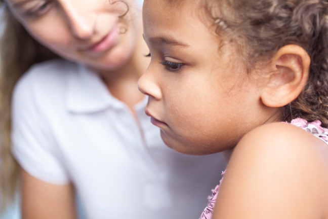 Woman talks with worried child