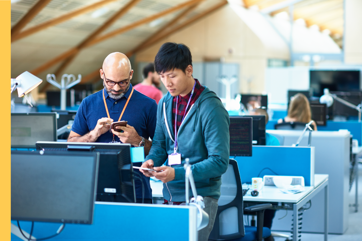 Office workers using mobile devices.