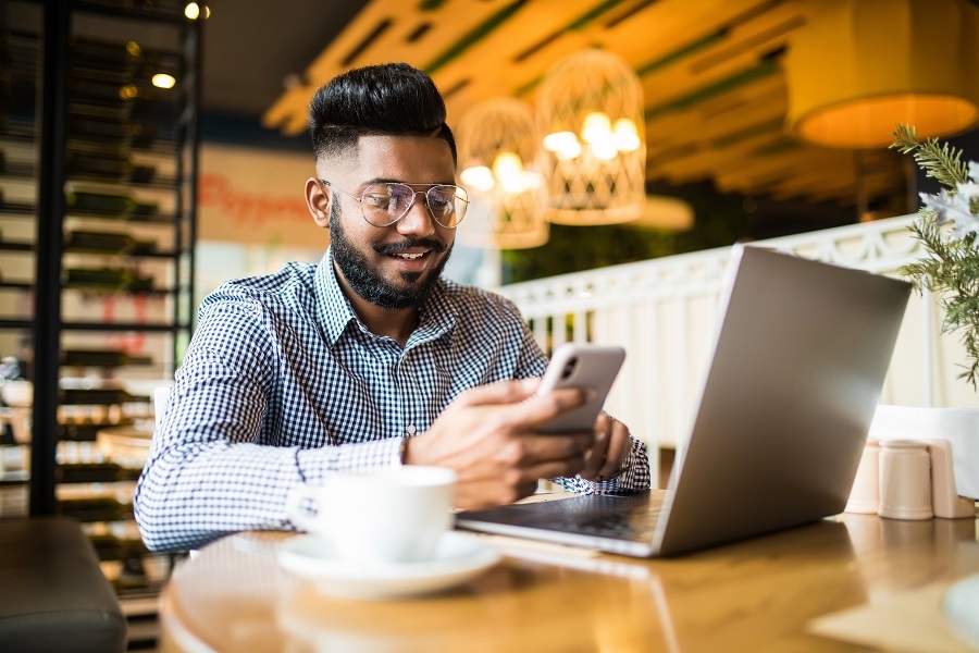 A man looking at computer screens