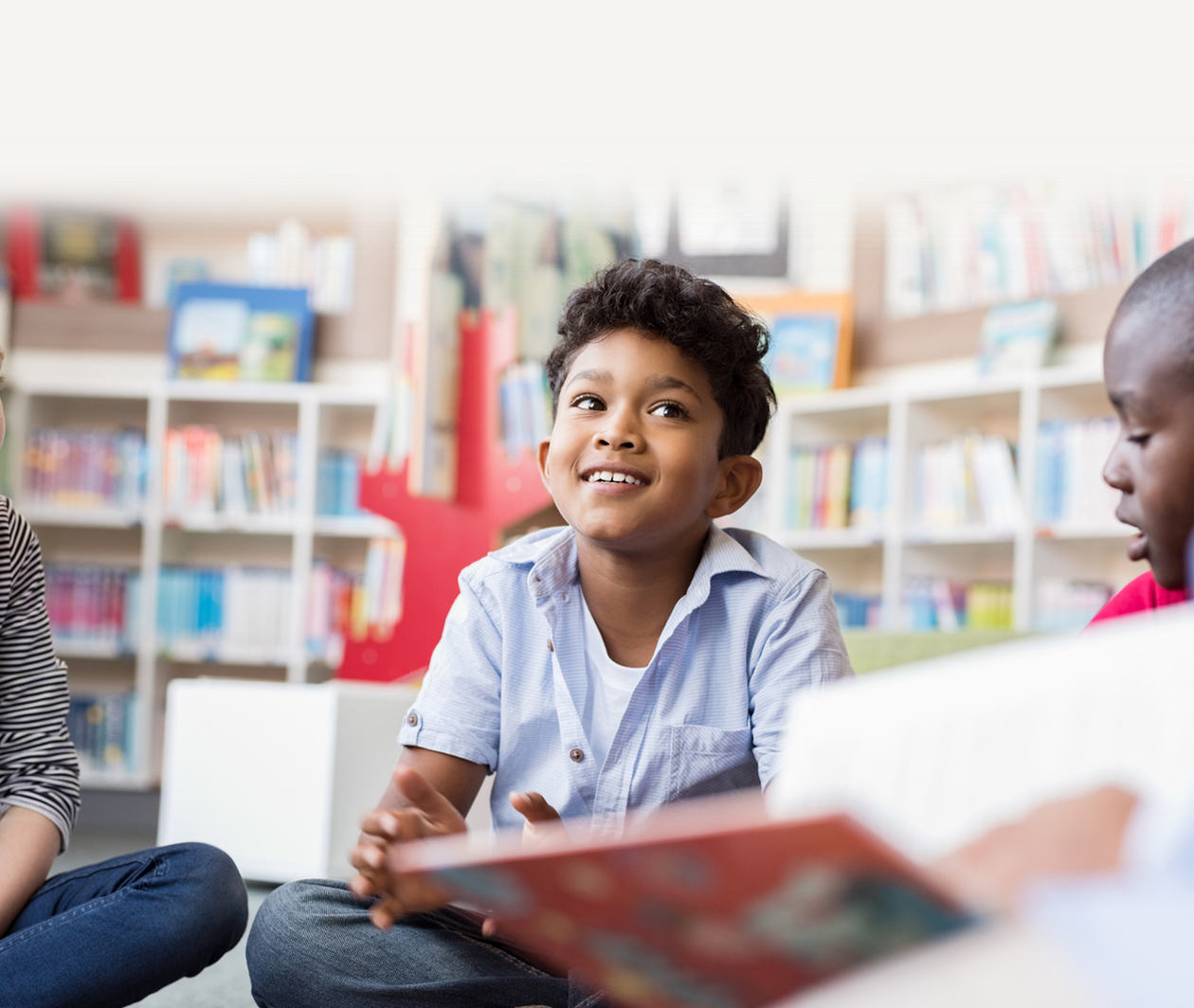 photo of young children sitting in a library