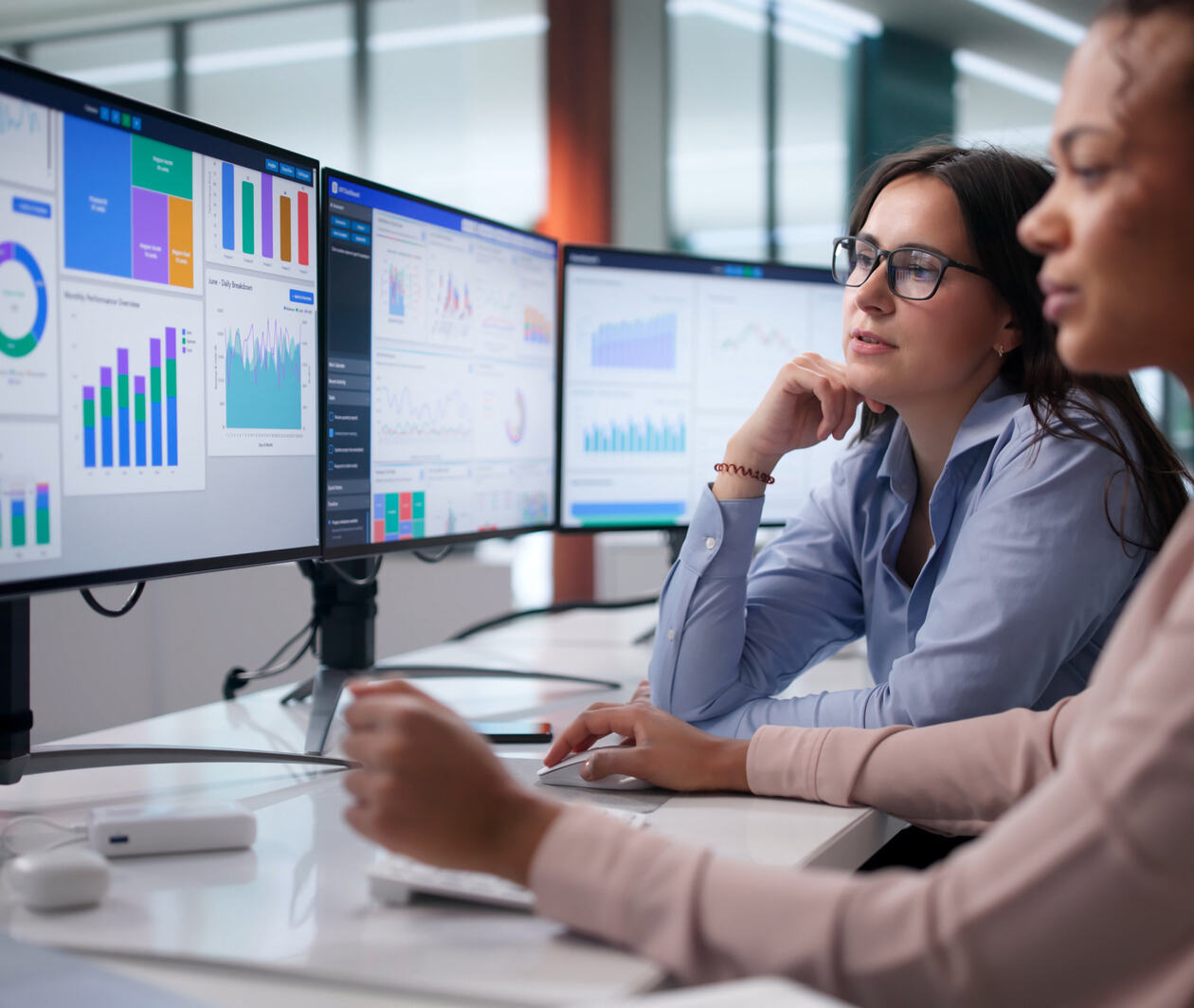 Two women looking at a screen of data