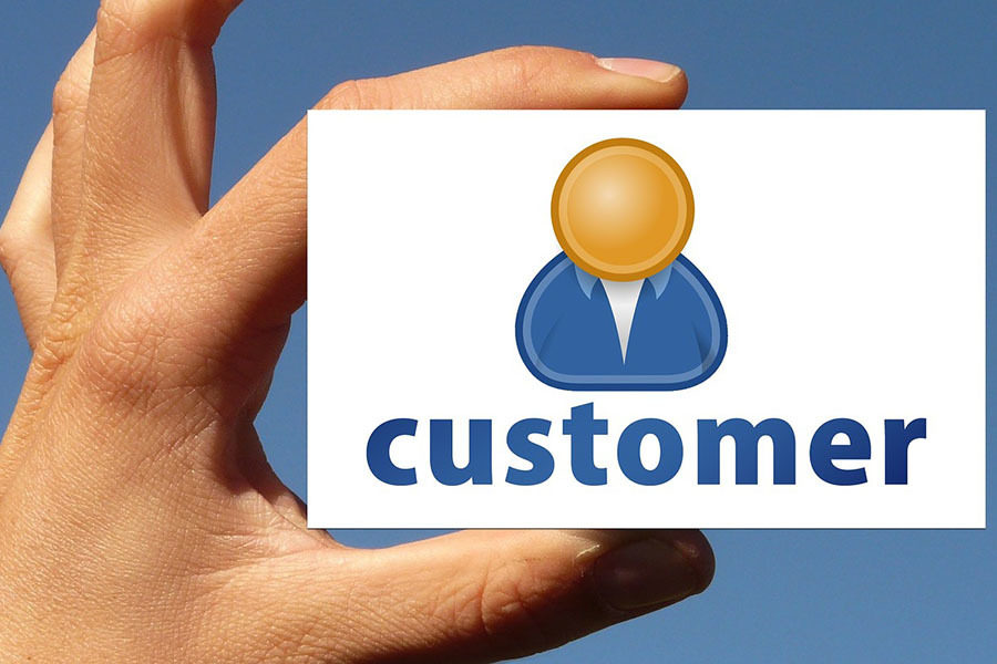 Hand holding card with the word customer