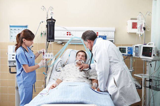 Unconscious patient in hospital bed