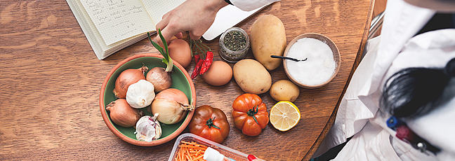 A scientist looking at different vegetables
